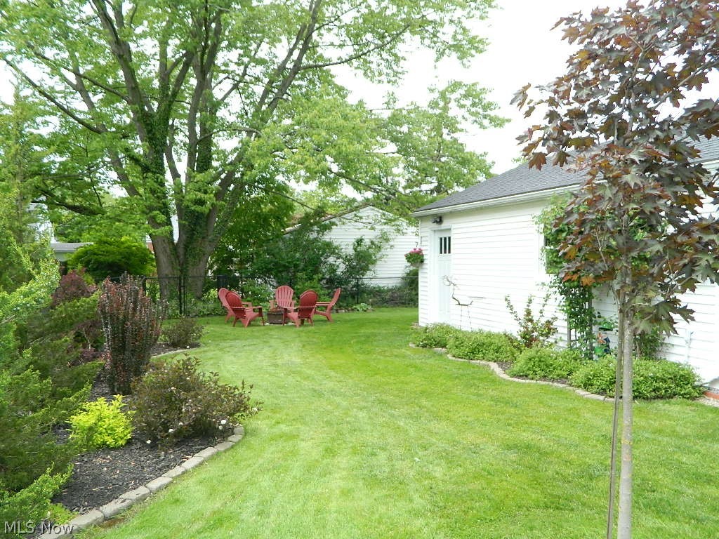 1604 Lyndhurst Road Lyndhurst, OH 44124 - Photo 30 of 35 You Will Be Wowed By this Back Yard; Beautifully Designed with Perennials, Shade, and Fire Pit in the Back Yard!