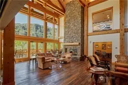 a living room with furniture and floor to ceiling windows