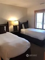 a bedroom with bed and window