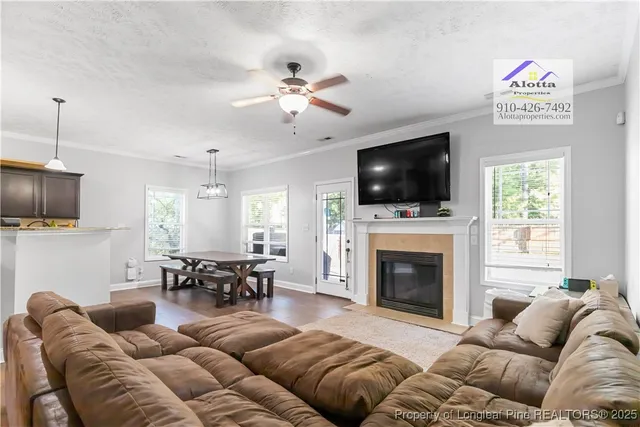 a living room with furniture fireplace and flat screen tv