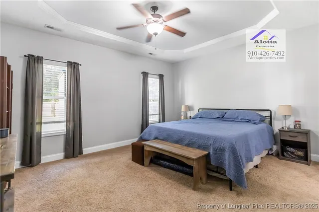 a spacious bedroom with a bed and a chandelier