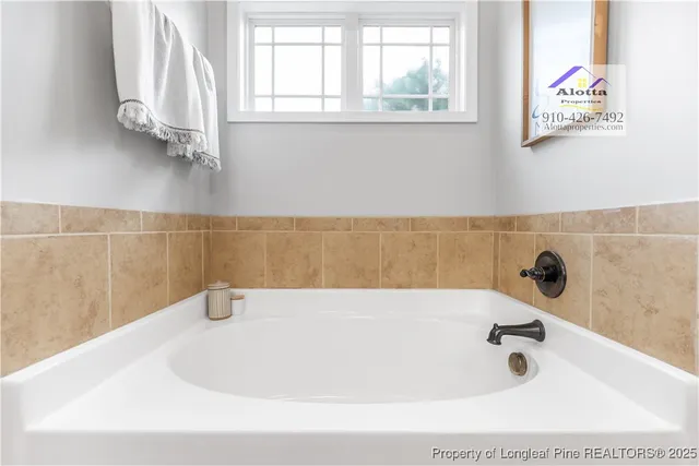 a bathroom with a tub and a window