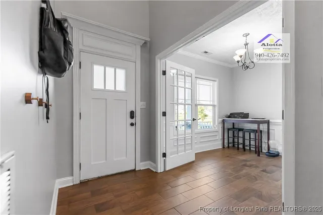 a view of livingroom with furniture cabinet front door and wooden floor