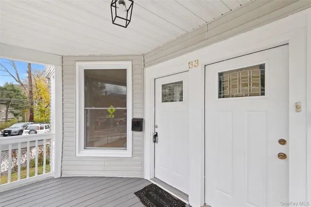 a view of an entryway with wooden floor