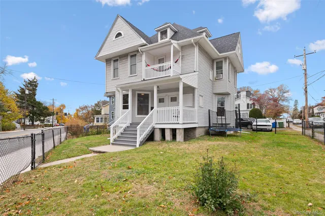 a front view of a house with a yard table and chairs