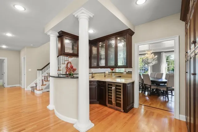 a living room with stainless steel appliances granite countertop furniture a rug and a window