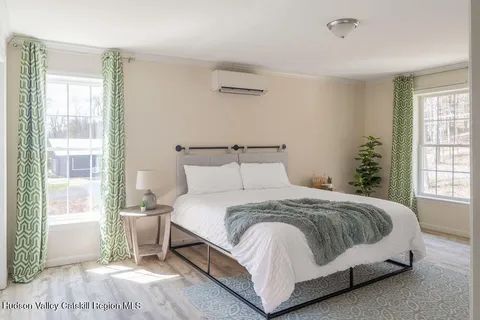a bedroom with a bed and large window