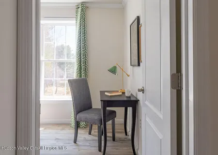 a view of a room with a table and chairs