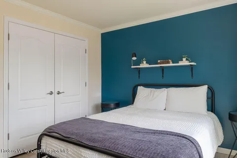 a bedroom with a bed and a wall painting