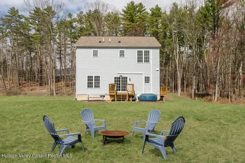 a view of a house with backyard sitting area and garden