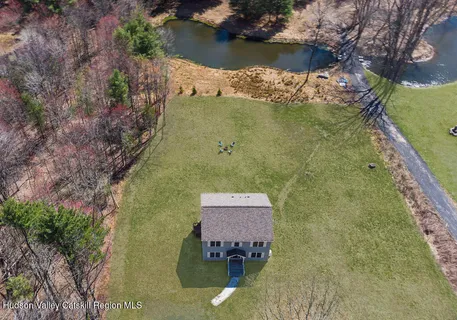an aerial view of a house with a lake view