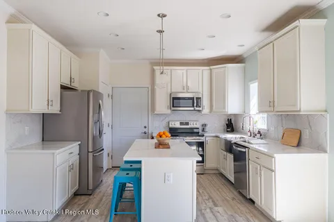 a kitchen with stainless steel appliances a stove refrigerator sink and cabinets