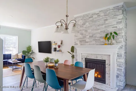 a living room with furniture a fireplace and a flat screen tv