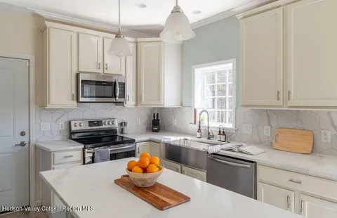 a kitchen with a sink appliances and cabinets