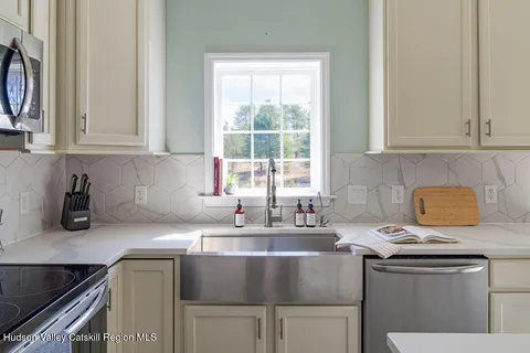 a kitchen with stainless steel appliances granite countertop a sink stove and cabinets