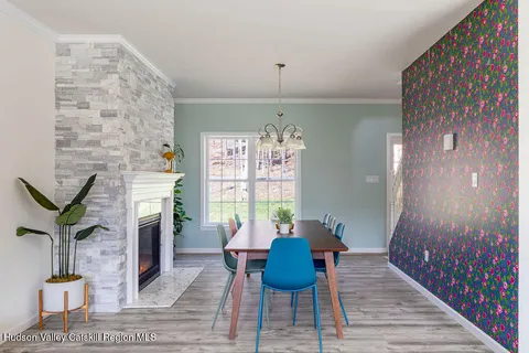 a view of a livingroom with furniture wooden floor and a chandelier