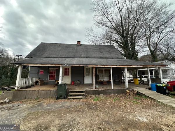 a front view of house with yard and car parked
