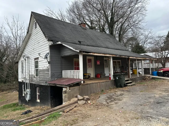 a view of a house with a patio and a yard