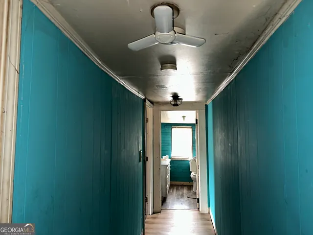 a view of a hallway with a yellow & plant