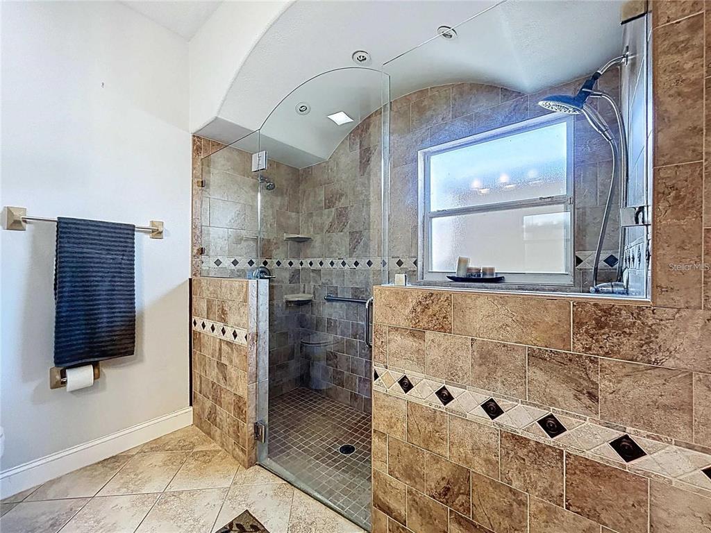 3324 West Abdella Street Tampa, FL 33607 - Photo 11 of 20 a spacious bathroom with a granite countertop sink a mirror and shower