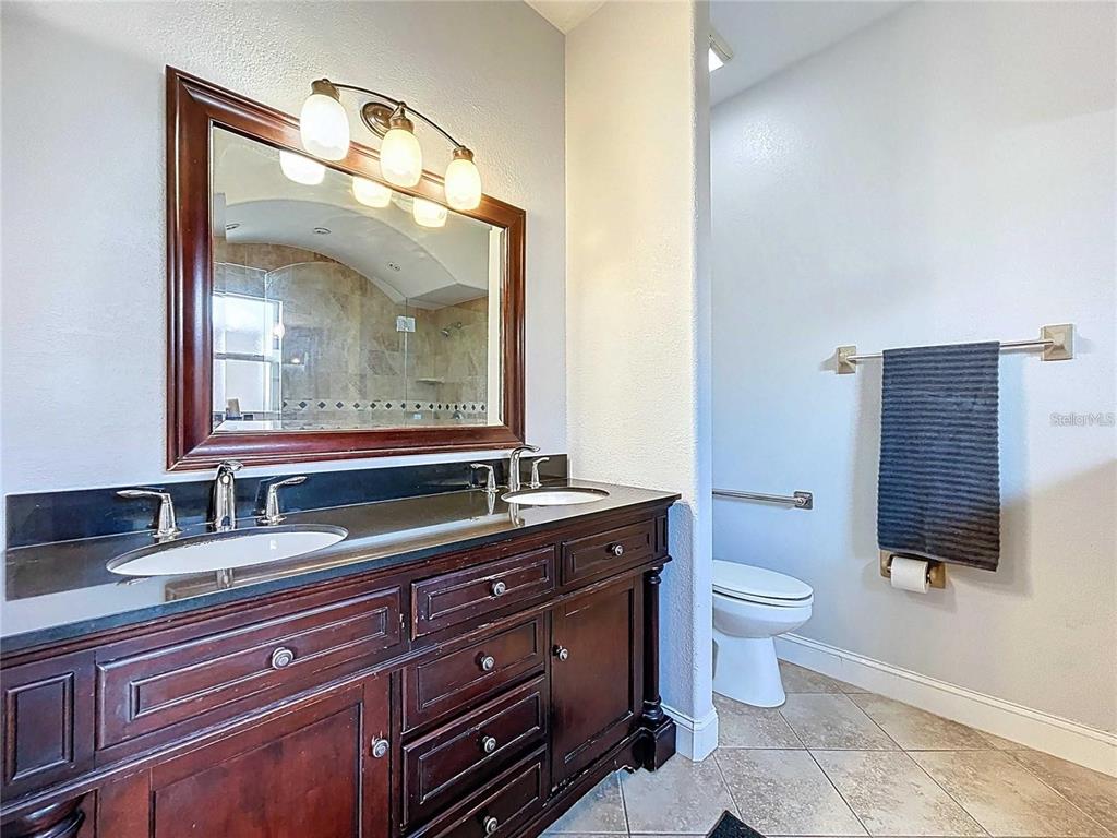 3324 West Abdella Street Tampa, FL 33607 - Photo 13 of 20 a bathroom with a toilet sink and mirror