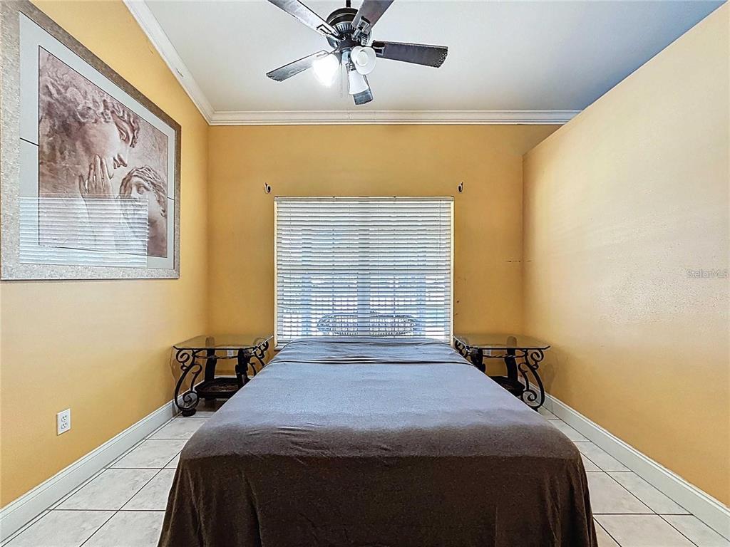 3324 West Abdella Street Tampa, FL 33607 - Photo 14 of 20 a bedroom with a bed and a chandelier