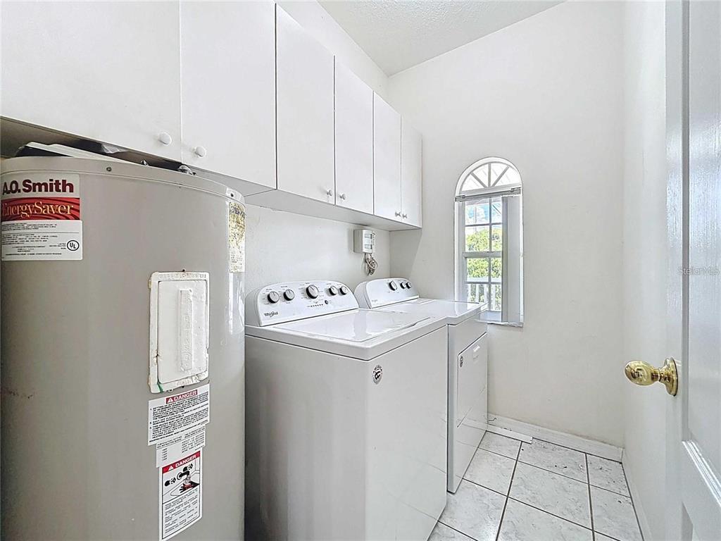 3324 West Abdella Street Tampa, FL 33607 - Photo 15 of 20 a utility room with cabinets washer and dryer