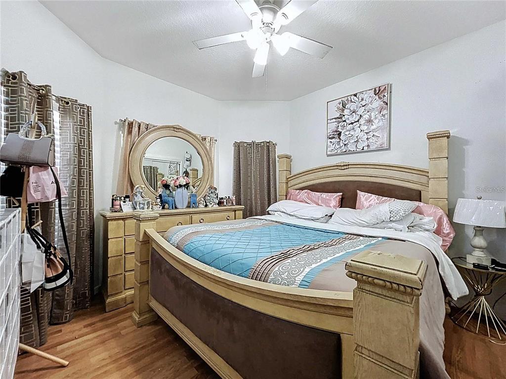 3324 West Abdella Street Tampa, FL 33607 - Photo 19 of 20 a bedroom with a bed and a chandelier