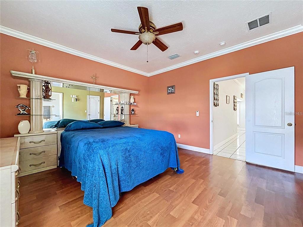 3324 West Abdella Street Tampa, FL 33607 - Photo 7 of 20 a bedroom with a bed and a chandelier