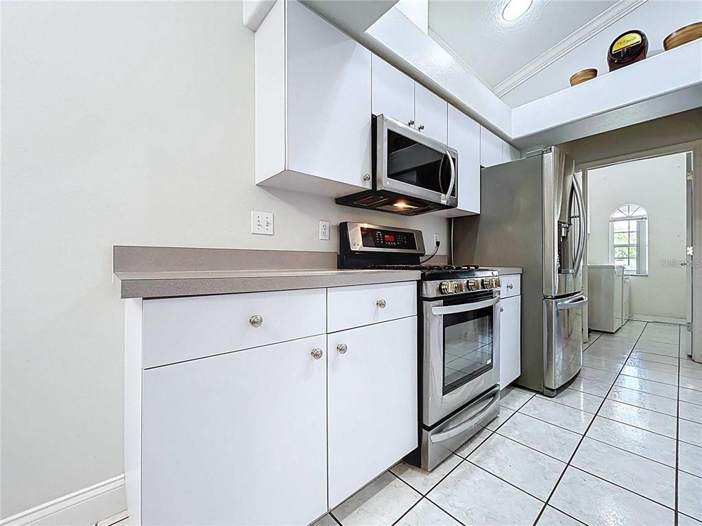 3324 West Abdella Street Tampa, FL 33607 - Photo 8 of 20 a kitchen with white cabinets stainless steel appliances and sink