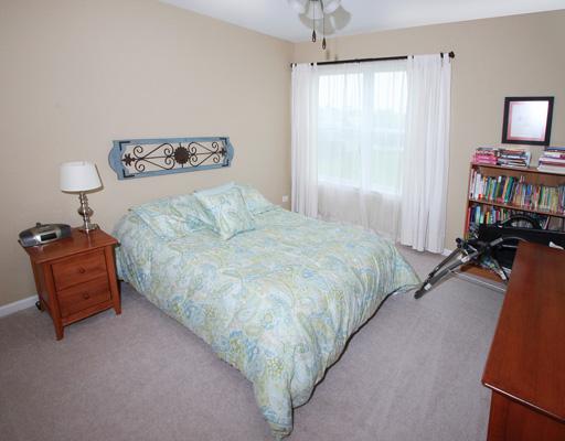 13523 Marigold Road Plainfield, IL 60544 - Photo 11 of 16 a bedroom with a bed and a tv on table