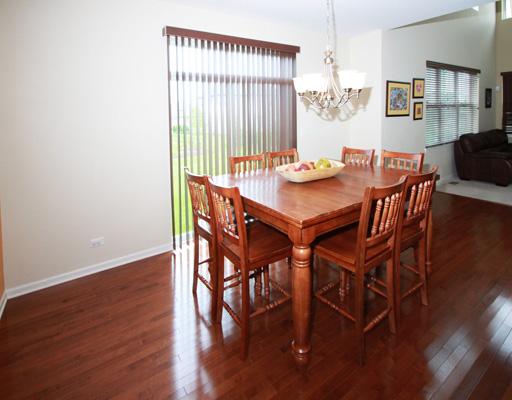 13523 Marigold Road Plainfield, IL 60544 - Photo 5 of 16 a view of a dining room with furniture and wooden floor
