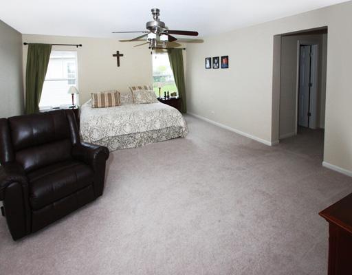 13523 Marigold Road Plainfield, IL 60544 - Photo 9 of 16 a bedroom with a bed couch and window