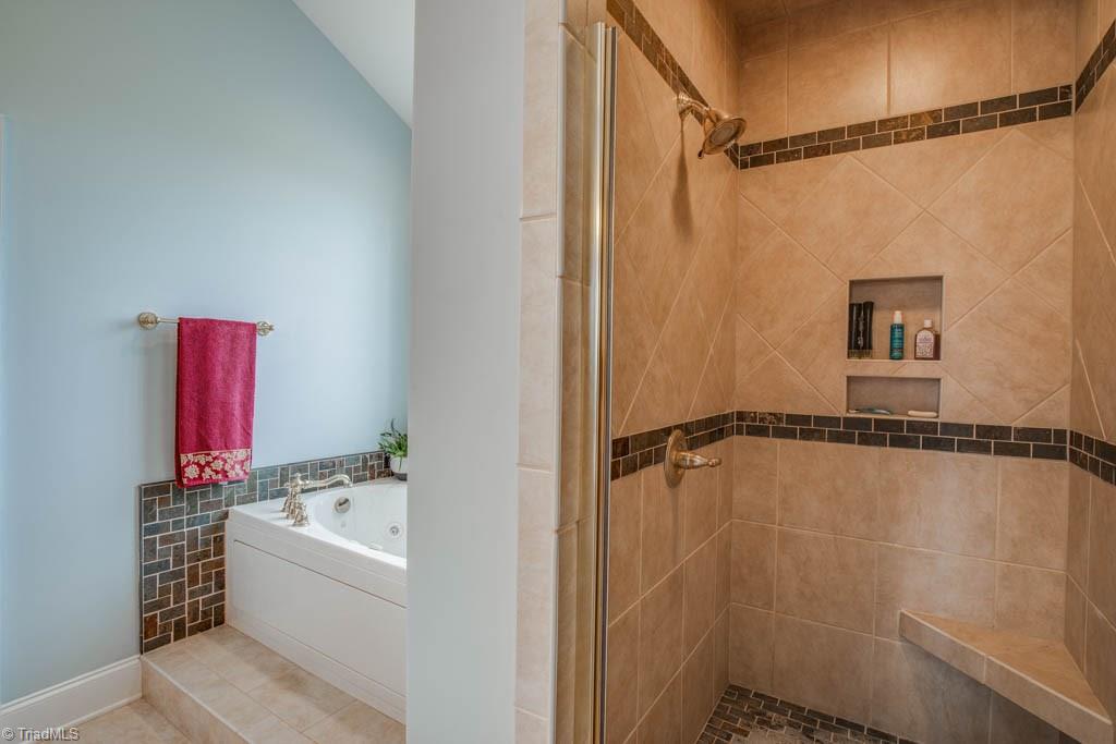 190 Baltimore Downs Road Advance, NC 27006 - Photo 14 of 30 Separate tiled shower with corner bench and niche