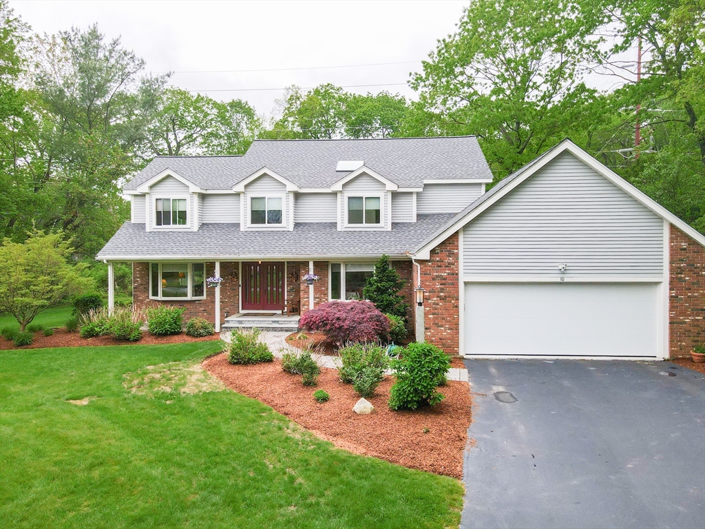 10 Grover Road Ashland, MA 01721 - Photo 1 of 41 a front view of a house with a garden and plants
