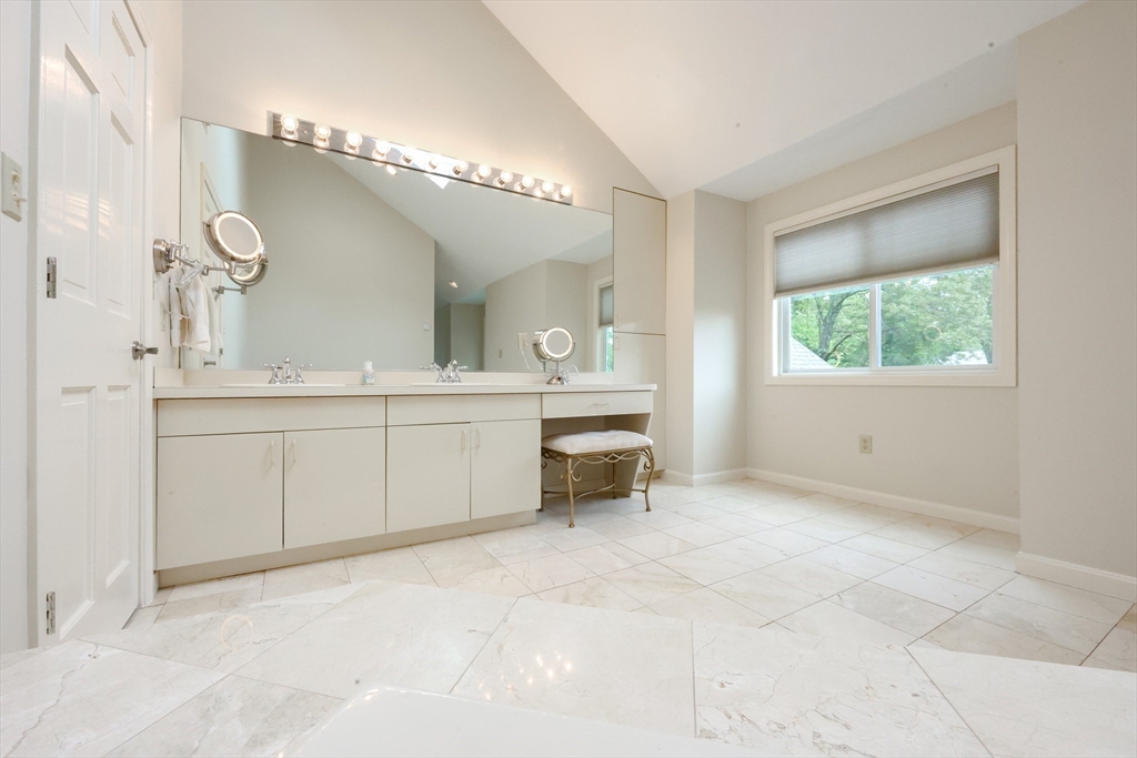 10 Grover Road Ashland, MA 01721 - Photo 11 of 41 a spacious bathroom with a double vanity sink a mirror and a bathtub