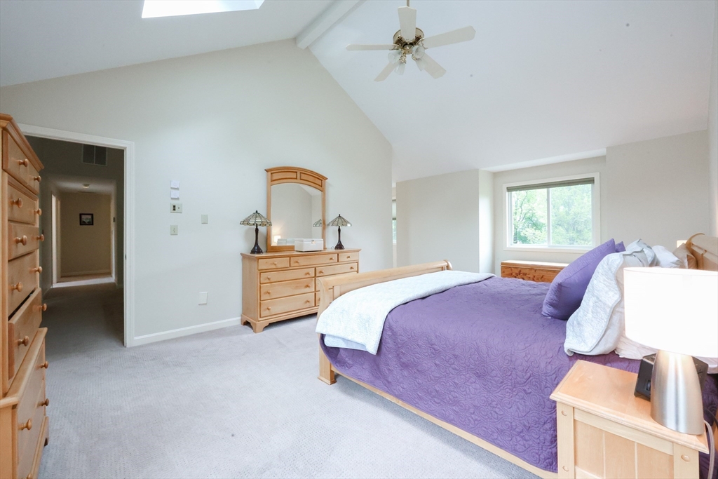 10 Grover Road Ashland, MA 01721 - Photo 15 of 41 a bedroom with a bed and a chandelier