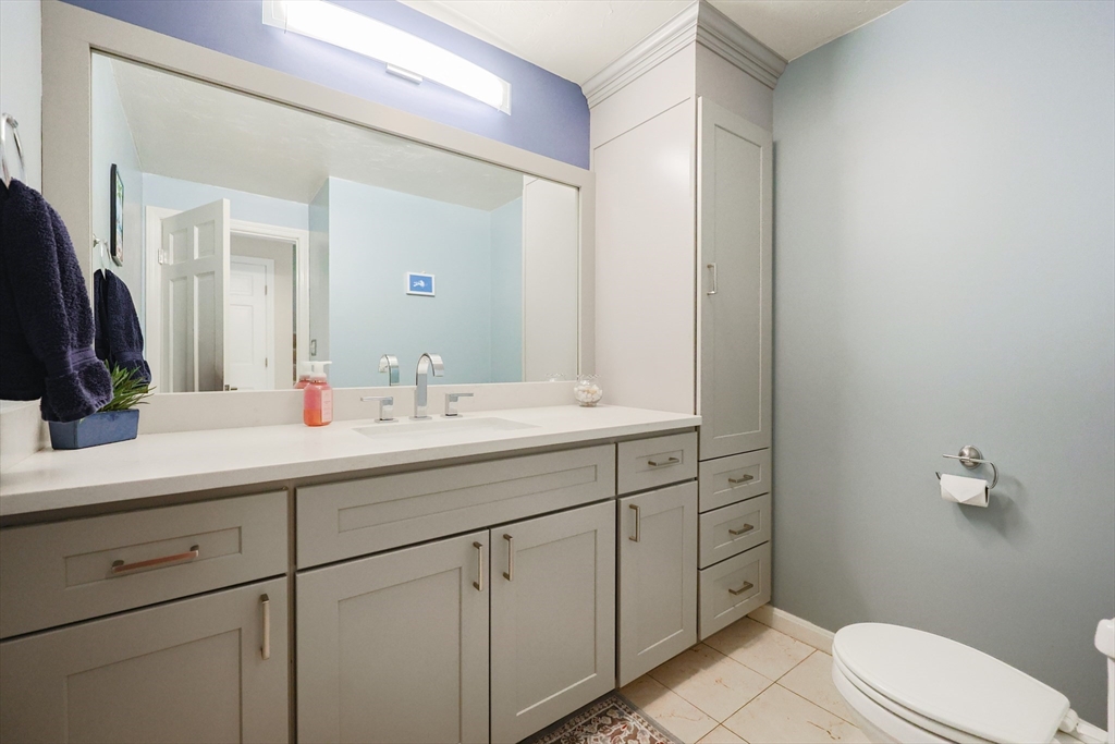 10 Grover Road Ashland, MA 01721 - Photo 17 of 41 a bathroom with a sink a toilet a mirror and vanity