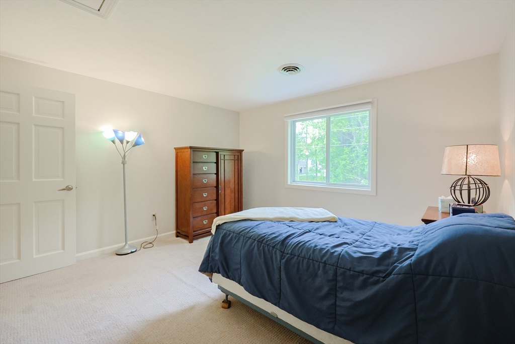 10 Grover Road Ashland, MA 01721 - Photo 20 of 41 a bedroom with a bed and a lamp