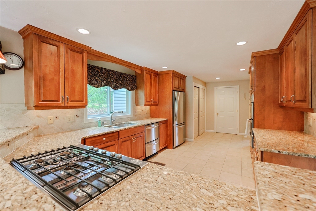 10 Grover Road Ashland, MA 01721 - Photo 31 of 41 a kitchen with stainless steel appliances granite countertop a stove a sink and a refrigerator