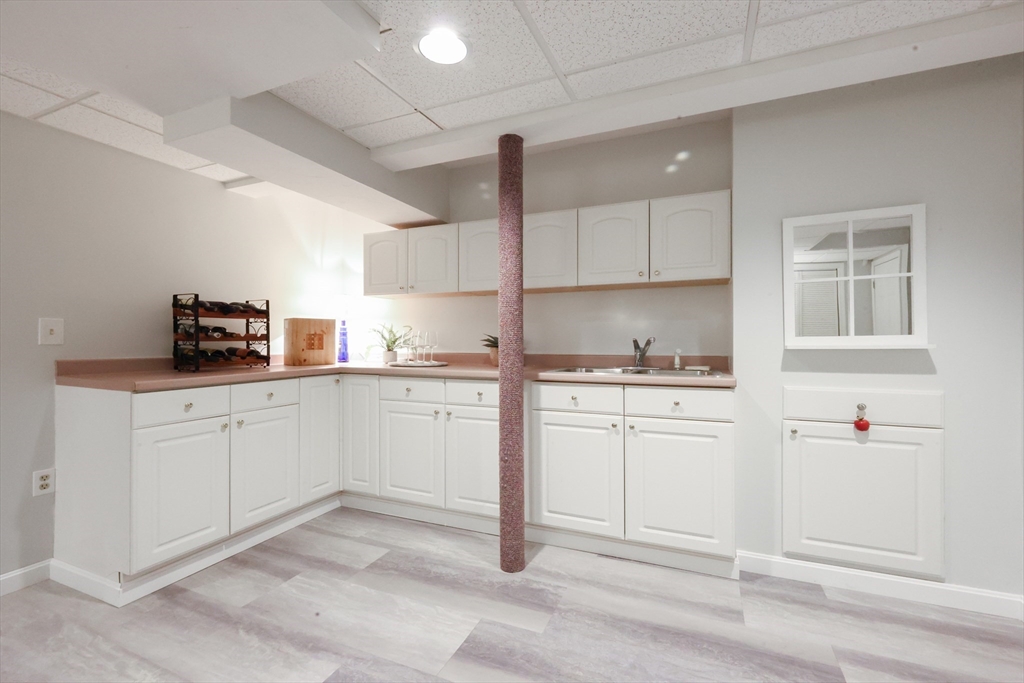10 Grover Road Ashland, MA 01721 - Photo 36 of 41 a kitchen with granite countertop white cabinets and white appliances