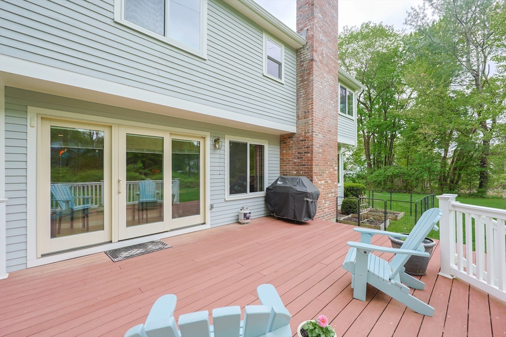 10 Grover Road Ashland, MA 01721 - Photo 39 of 41 a view of a deck with table and chairs and wooden floor