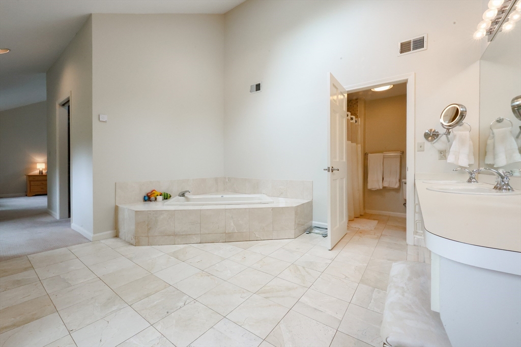 10 Grover Road Ashland, MA 01721 - Photo 9 of 41 a spacious bathroom with a tub sink and mirror