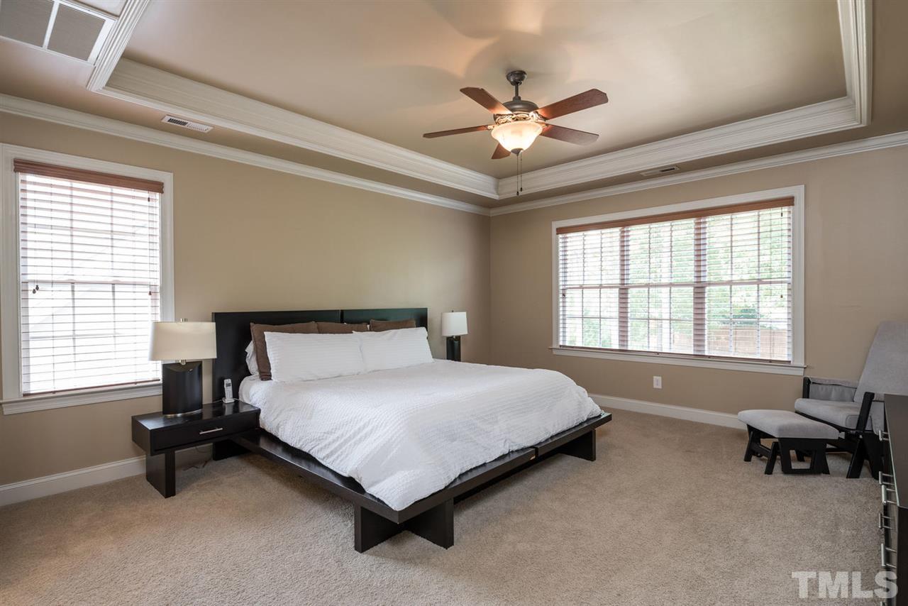 11511 Azari Court Raleigh, NC 27614 - Photo 12 of 25 a bedroom with a bed and a chandelier