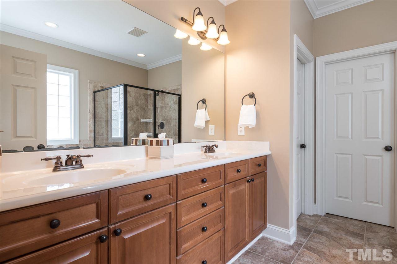 11511 Azari Court Raleigh, NC 27614 - Photo 13 of 25 a bathroom with a double vanity sink and a mirror