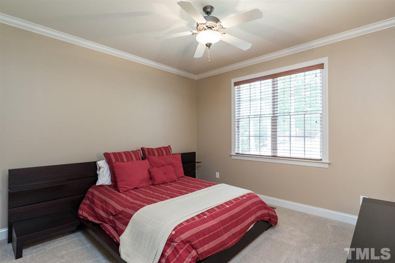 11511 Azari Court Raleigh, NC 27614 - Photo 19 of 25 a bedroom with a bed and a chandelier