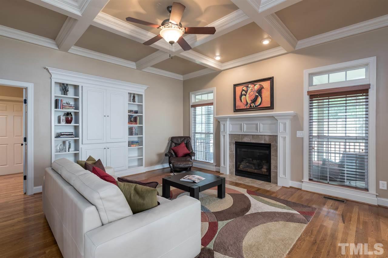 11511 Azari Court Raleigh, NC 27614 - Photo 6 of 25 a living room with furniture a fireplace and a flat screen tv