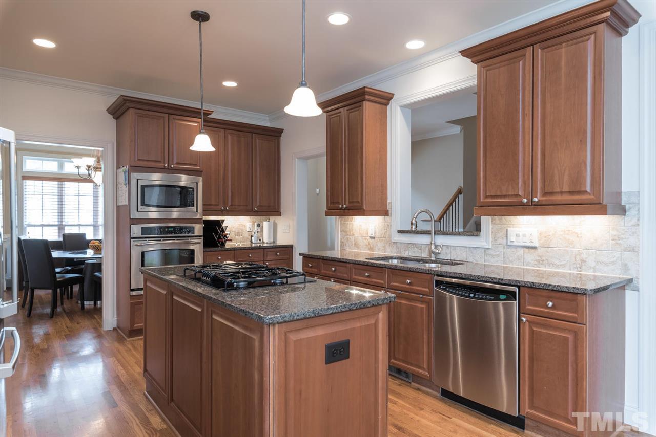 11511 Azari Court Raleigh, NC 27614 - Photo 9 of 25 a kitchen with stainless steel appliances granite countertop a stove a sink and a microwave
