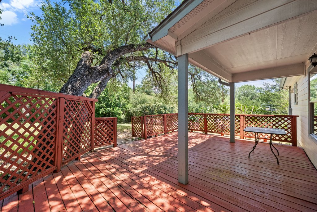 5208 Sioux Lane Austin, TX 78734 - Photo 34 of 35 A spacious covered deck offers serene outdoor living amidst mature trees and natural surroundings.