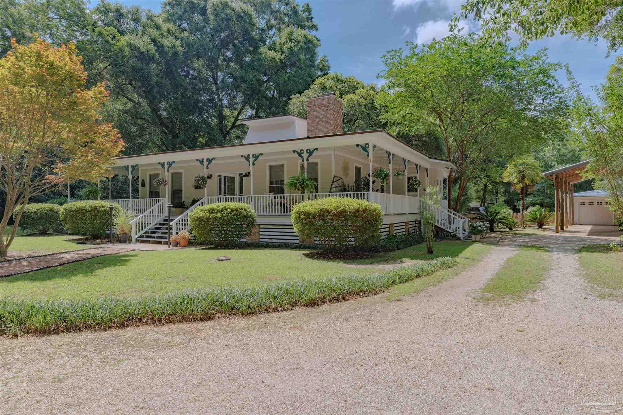 5049 Guernsey Road Pace, FL 32571 - Photo 1 of 61 a front view of a house with garden